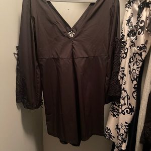 Dressy black romper with lace filigree sleeves